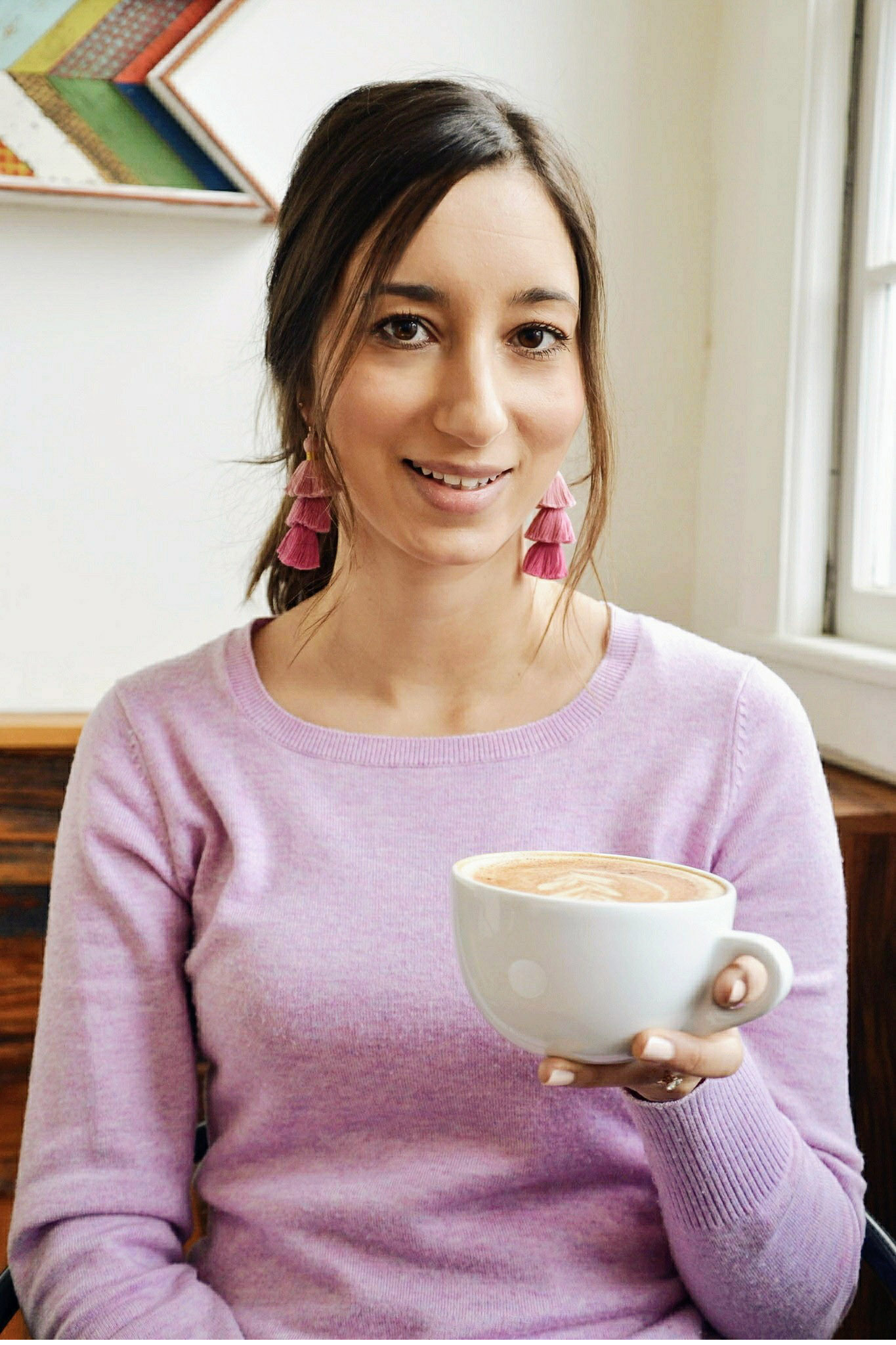 Wearing ombre pink tassel earrings and drinking chai tea latte at Origin Coffee in Saranac Lake, New York